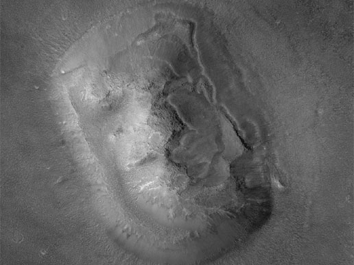 A higher-resolution Mars Global Surveyor view of the Cydonia landform. With improved resolution and different lighting, the apparent face resolves into ordinary topography.
