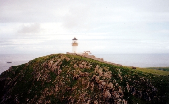Eilean Mor with the Flannan Isles lighthouse and the Chapel of St Flann visible on the slope below.
