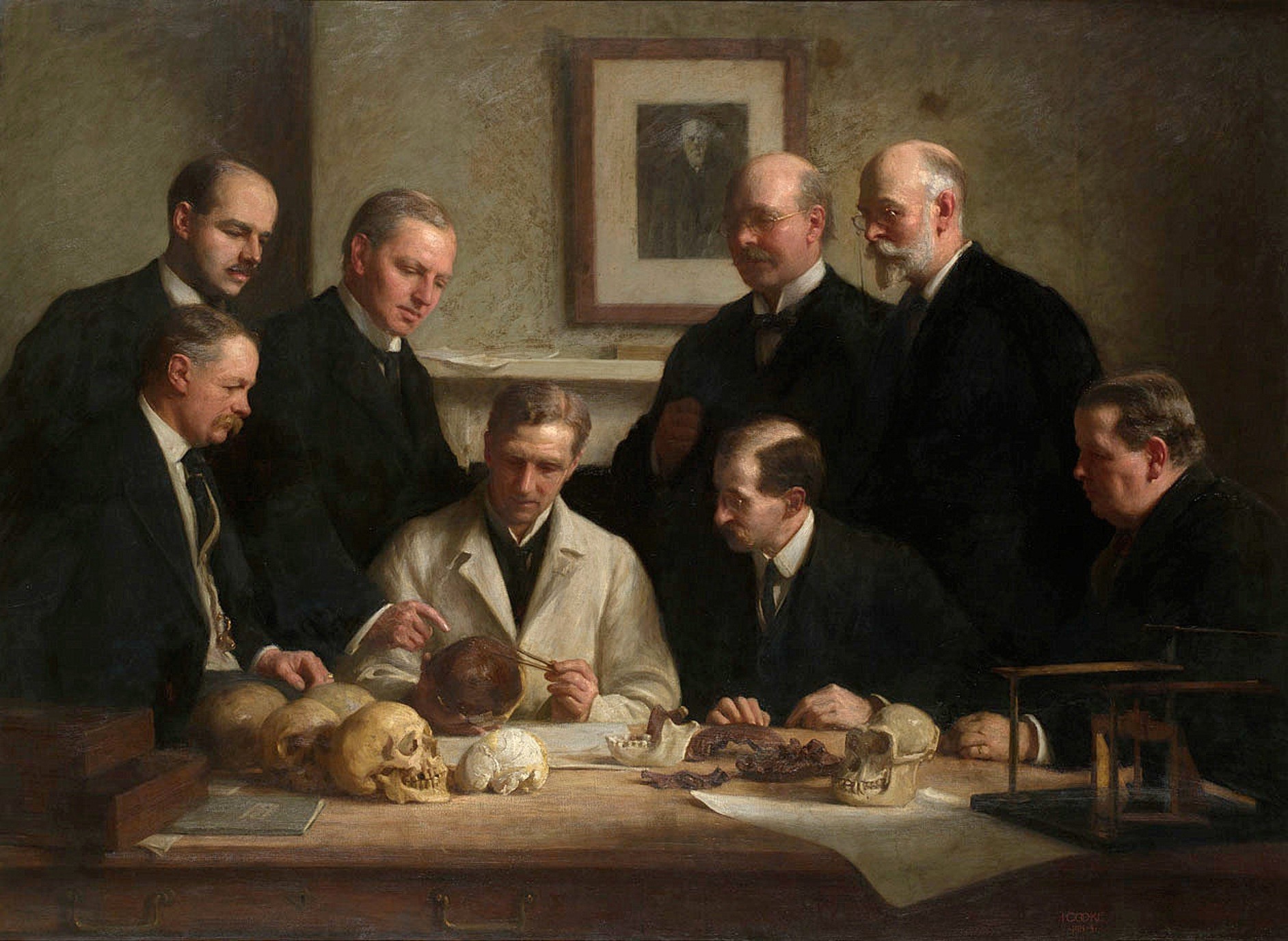 John Cooke's 1915 group portrait stages the Piltdown skull under examination, capturing the authority that gathered around the find before its exposure.
